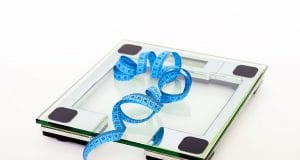 blue tape measuring on clear glass square weighing scale 53404