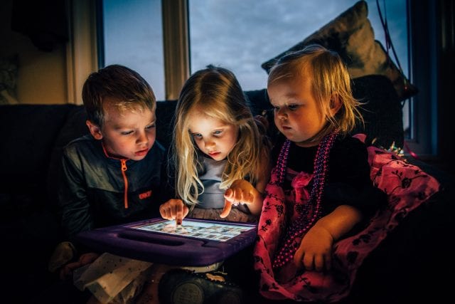 three children looking at a tablet computer 3536480