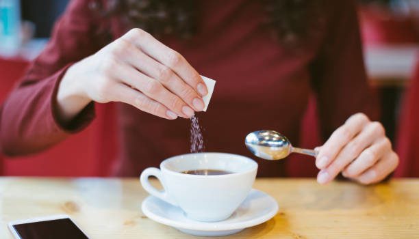 Picture of female hands with coffee and sugar